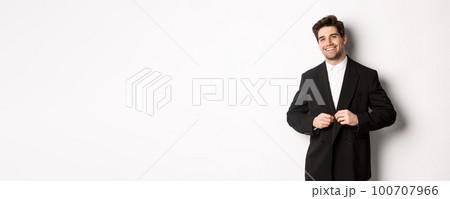 Image of handsome and confident businessman with beard, button down jacket and smiling, standing against white background Image of handsome and confident businessman with beard, button down jacket and smiling, standing against white background 100707966