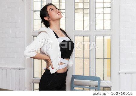Office syndrome concept. Businesswoman twisting the body to relieve fatigue , suffering from pain after sedentary working in incorrect posture. Office syndrome concept. Businesswoman twisting the body to relieve fatigue , suffering from pain after sedentary working in incorrect posture. 100710019