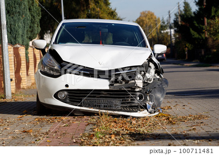 Front of white coloured car large damaged and broken by car park accident can't go on 100711481