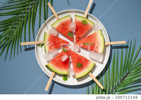 Watermelon popsicles in a plate with ice cubes. Summer food background 100712148