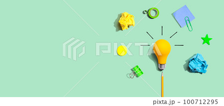 Brainstorming concept with a light bulb and school supplies - Flat lay Brainstorming concept with a light bulb and school supplies - Flat lay 100712295