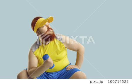 Funny chubby man working out with dumbbells, thinking and looking at copy space background 100714525