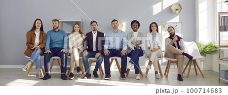 Portrait of group of people sitting in row on chairs and who are listeners or candidates. Portrait of group of people sitting in row on chairs and who are listeners or candidates. 100714683