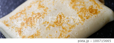 Pancake stuffed with meat cheese and fruit closeup 100715665