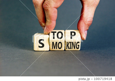 Stop smoking symbol. Concept words Stop smoking on wooden cubes. Beautiful grey table grey background. Doctor hand. Medical, healthy lifestyle and stop smoking concept. Copy space. 100719418