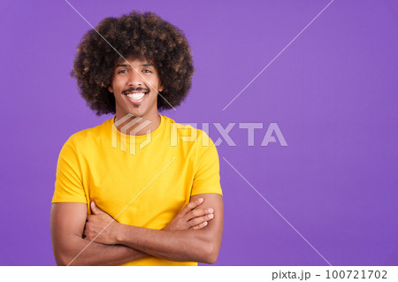 Happy african man looking at camera with arms crossed 100721702
