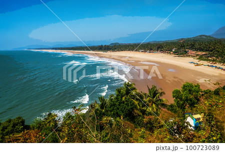 Amazing view on beach of some town or village oin Goa, |J=Karnataka or Kerala - People in distance on beach . 100723089