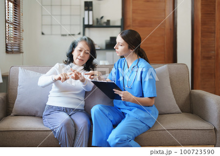 Portrait of a female doctor holding a patient clipboard to discuss and analyze wrist and finger pain 100723590