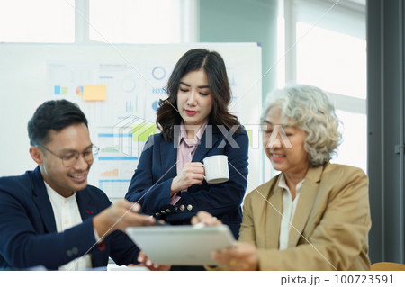 Asian entrepreneurs and business people meeting in a conference room in business planning, financial budget and investment risk assessment to analyze customer groups to increase company growth. Asian entrepreneurs and business people meeting in a conference room in business planning, financial budget and investment risk assessment to analyze customer groups to increase company growth. 100723591