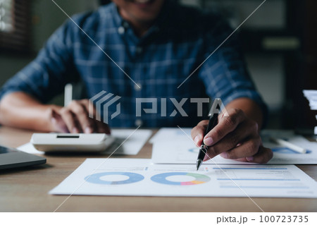 financial, Planning, Marketing and Accounting, portrait of Asian woman Economist using calculator to calculate investment documents with partners on profit taking to compete with other companies. 100723735