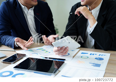 financial, Planning, Marketing and Accounting, Asian young Economist using calculator to calculate investment documents with partners on profit taking to compete with other companies. 100723772