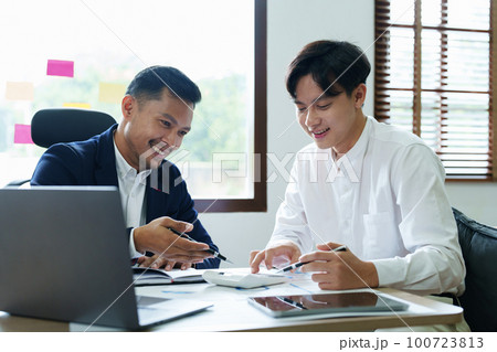 financial, Planning, Marketing and Accounting, Asian young Economist using calculator to calculate investment documents with partners on profit taking to compete with other companies 100723813
