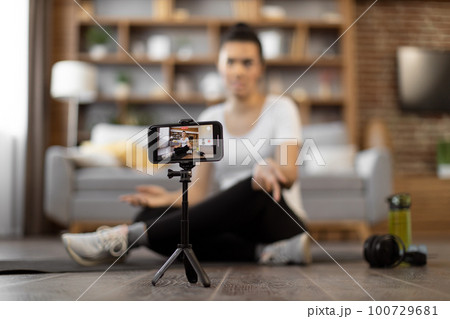 Personal coach guiding fitness training online 100729681