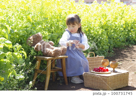 自然と遊ぶ菜の花畑の中の少女 自然と遊ぶ菜の花畑の中の少女 100731745