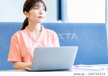 カルテの情報をパソコンに登録する若い女性 100734224