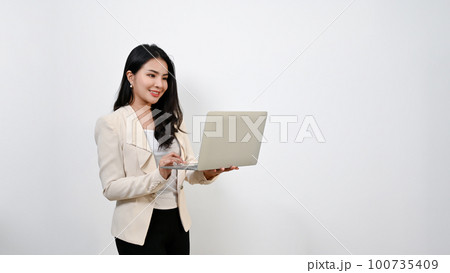 Beautiful millennial Asian businesswoman using her laptop. isolated white background. 100735409