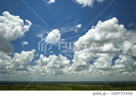 White puffy cumulus clouds on summer blue sky White puffy cumulus clouds on summer blue sky 100735498