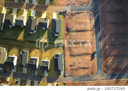 View from above of densely built residential houses under construction in south Carolina residential area. American dream homes as example of real estate development in US suburbs View from above of densely built residential houses under construction in south Carolina residential area. American dream homes as example of real estate development in US suburbs 100737260