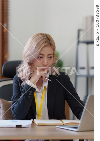 Beautiful Business woman analysis and research with financial graph at home office. Strategy, chart, finance report concept 100738599