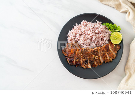 spicy grilled Jamaican jerk chicken with rice 100740941
