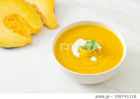 pumpkin soup in white bowl 100741116