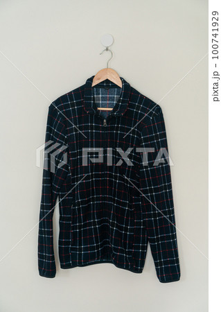 black jacket hanging with wood hanger 100741929