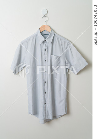 hanging shirt with wood hanger on wall 100742053