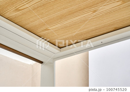 Minimalism style dining table with thin wooden table top of oak veneer on white metal legs in workshop closeup low angle view 100745520