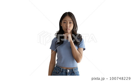 Asian woman doing silent gesture with finger, Noiseless symbol, Noisy mall, Hide a secret, Do not speak. shut your mouth, Noiseless signal transmission, Isolated on white background. 100748229