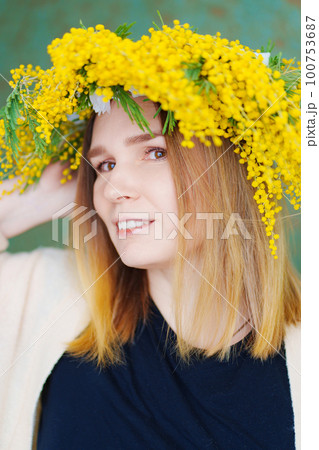 middle-aged woman in a wreath of mimosa middle-aged woman in a wreath of mimosa 100753687