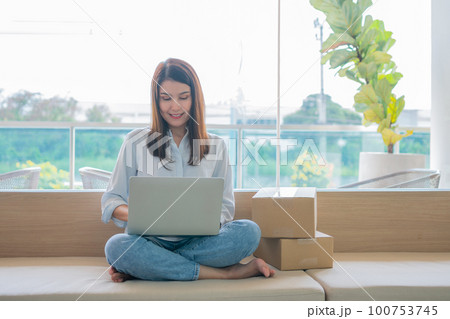 Happy young Asian woman entrepreneur, Smile for sales success after checking order from online shopping store in a laptop at home office, Concept of merchant business online and eCommerce Happy young Asian woman entrepreneur, Smile for sales success after checking order from online shopping store in a laptop at home office, Concept of merchant business online and eCommerce 100753745