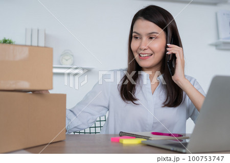 Happy young Asian woman entrepreneur, talk with a supplier and Smile for sale success of online shopping store at home office, Concept of the merchant, small business, online business, and eCommerce. Happy young Asian woman entrepreneur, talk with a supplier and Smile for sale success of online shopping store at home office, Concept of the merchant, small business, online business, and eCommerce. 100753747