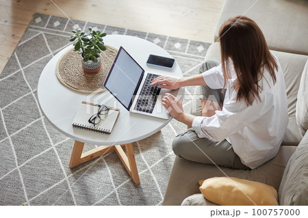 Mockup white screen laptop woman using computer sitting on sofa at home, top view Mockup white screen laptop woman using computer sitting on sofa at home, top view 100757000