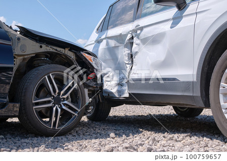 Damaged in heavy car accident vehicles after collision on city street crash site. Road safety and insurance concept 100759657