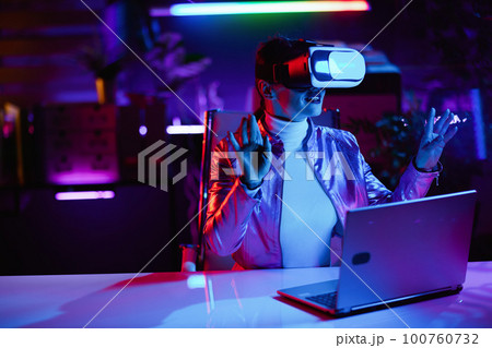 happy woman designing virtual reality in office 100760732