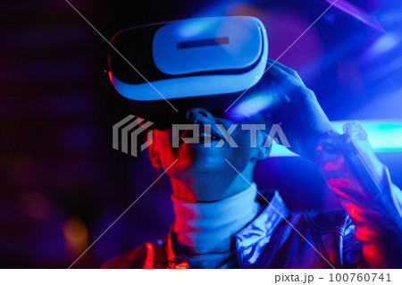 modern woman in virtual reality goggles on dark background modern woman in virtual reality goggles on dark background 100760741