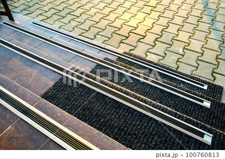 Closeup of ceramic tiles covering porch stairs with rubber anti slippery stripes on it. 100760813