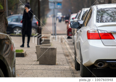 Cars parked in a row on a city street side. Cars parked in a row on a city street side. 100760948