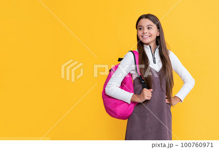 cheerful child with school bag on yellow background cheerful child with school bag on yellow background 100760971