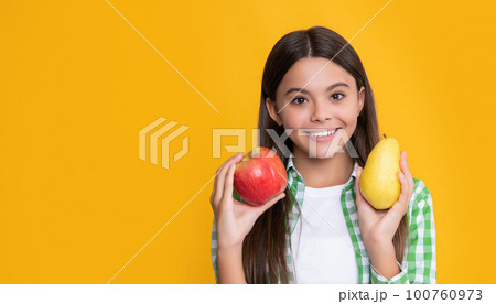 happy kid with apple and pear on yellow background happy kid with apple and pear on yellow background 100760973