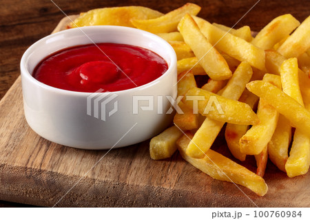 French fries, potato snack with a dip, fast food on a wooden table French fries, potato snack with a dip, fast food on a wooden table 100760984