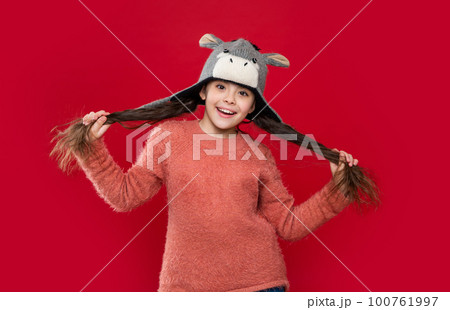 happy teen child wear sweater and earflap hat in studio. winter fashion for teen child. happy teen child wear sweater and earflap hat in studio. winter fashion for teen child. 100761997