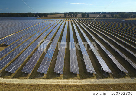 Aerial view of large sustainable electrical power plant with rows of solar photovoltaic panels for producing clean electric energy. Concept of renewable electricity with zero emission 100762800