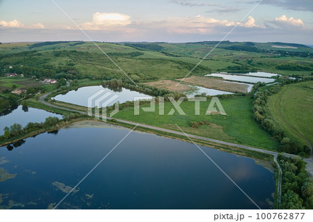 Aerial view of fish hetching pond with blue water in aquacultural area 100762877