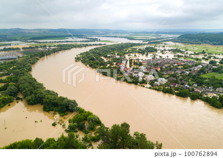 Aerial view of Dnister river with dirty water and flooded houses in Halych town, western Ukraine. Aerial view of Dnister river with dirty water and flooded houses in Halych town, western Ukraine. 100762894