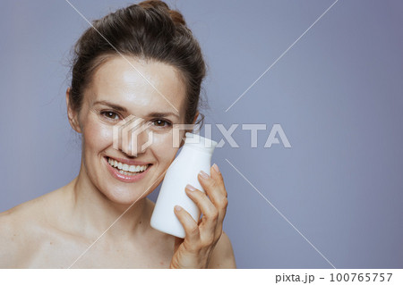happy young female with cosmetic cream jar happy young female with cosmetic cream jar 100765757
