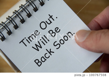 Top view of Time Out. Will Be Back Soon text on white notepad. Business and notification concept. 100767508