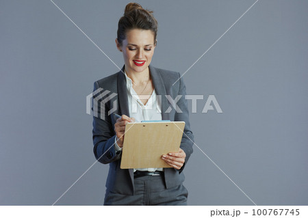happy elegant 40 years old business woman isolated on grey happy elegant 40 years old business woman isolated on grey 100767745