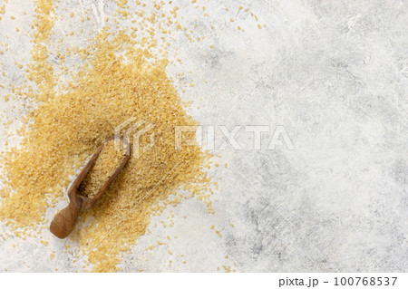 Wooden scoop of Dry uncooked bulgur wheat grain top view, copy space. Healthy food Wooden scoop of Dry uncooked bulgur wheat grain top view, copy space. Healthy food 100768537
