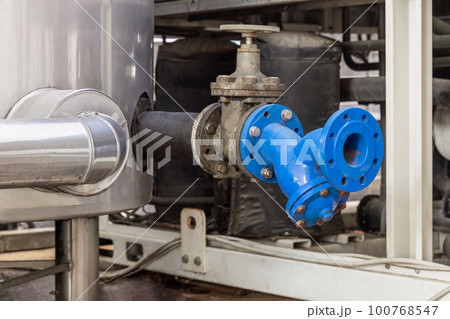 Handwheel type blue metal valve and pipes, industrial equipment at wine factory, close up Handwheel type blue metal valve and pipes, industrial equipment at wine factory, close up 100768547